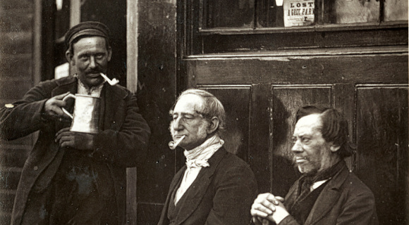 Men outside a shop drinking and smoking